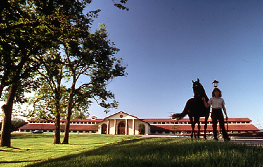 Woman with horse in front of Equestrian Center building (nd)